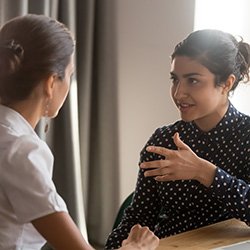 Two women talking face to face